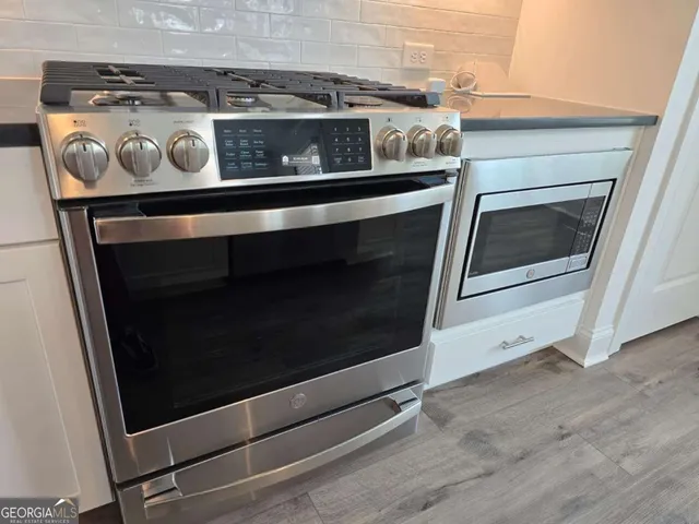 a stove top oven sitting inside of a kitchen