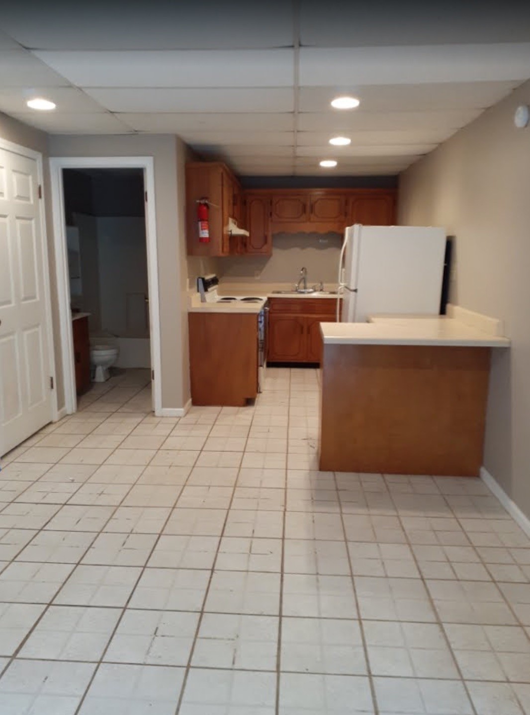 85 Lawn Street, Unit D Clarksville, TN 37040 - Photo 3 of 5 a room with kitchen island stainless steel appliances a sink a counter top space and cabinets
