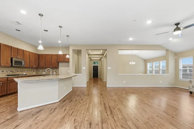a view of kitchen with sink and wooden floor