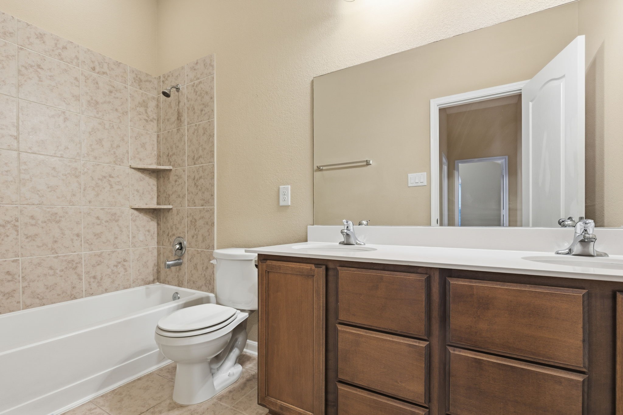 1810 Nantz Lane Conroe, TX 77304 - Photo 13 of 23 a bathroom with a toilet a sink a mirror a bathtub and vanity