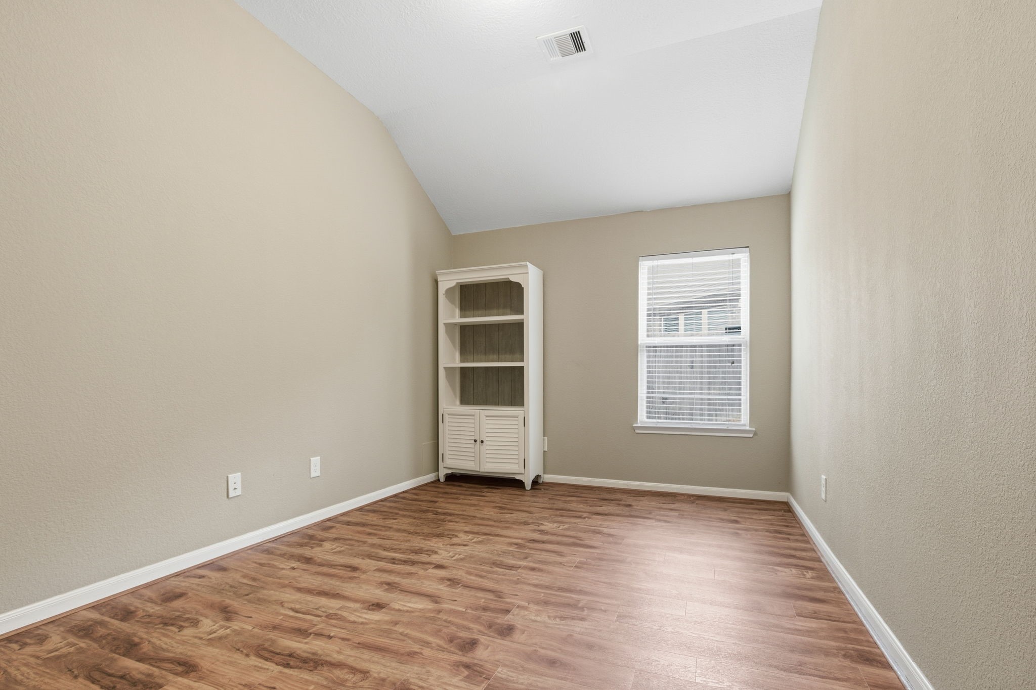 1810 Nantz Lane Conroe, TX 77304 - Photo 15 of 23 an empty room with wooden floor and windows