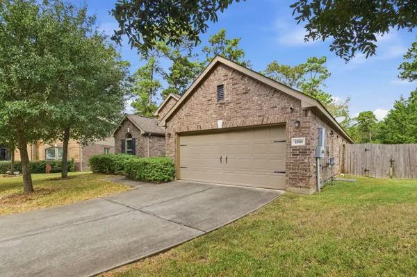 a view of a house with a yard and garage