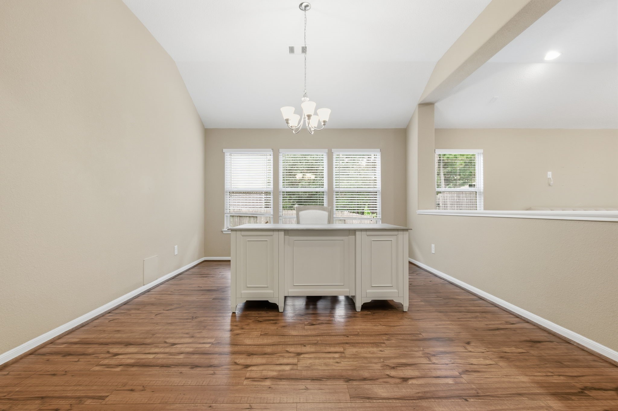 1810 Nantz Lane Conroe, TX 77304 - Photo 9 of 23 a view of an empty room with wooden floor and a window