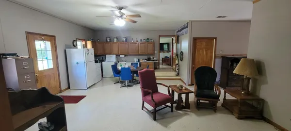 a living room with furniture and a lamp