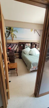 a bedroom with a bed and a mirror