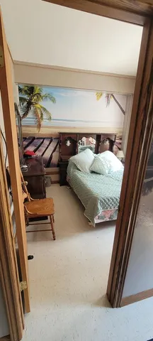 a bedroom with a bed and a mirror