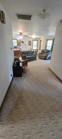 a living room with furniture and a chandelier