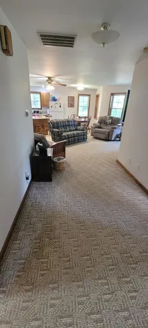 a living room with furniture and a chandelier