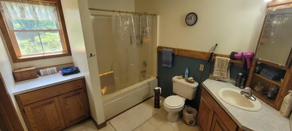 a bathroom with a sink mirror vanity and toilet