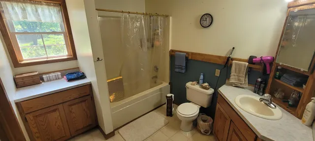 a bathroom with a sink mirror vanity and toilet