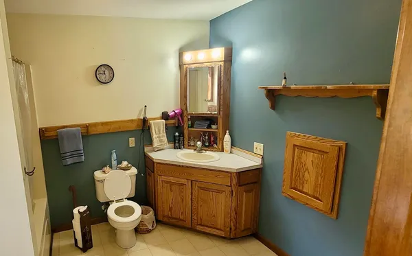 a bedroom with a bed and a chair