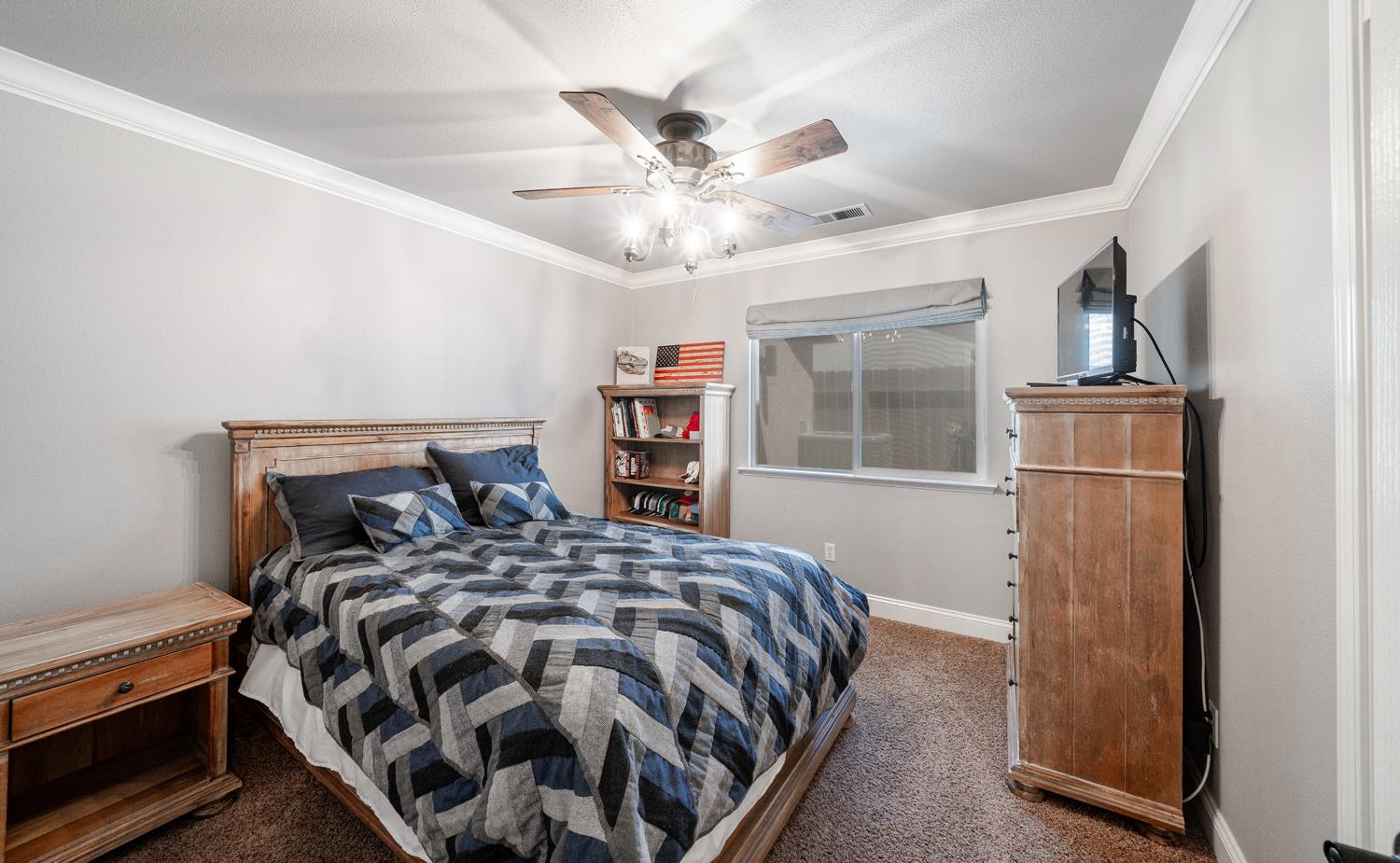 2232 Howard Street Kingsburg, CA 93631 - Photo 11 of 20 a bedroom with a bed and a window with a chandelier