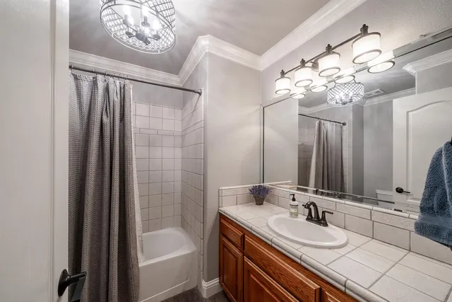 a bathroom with a double vanity sink mirror and bathtub
