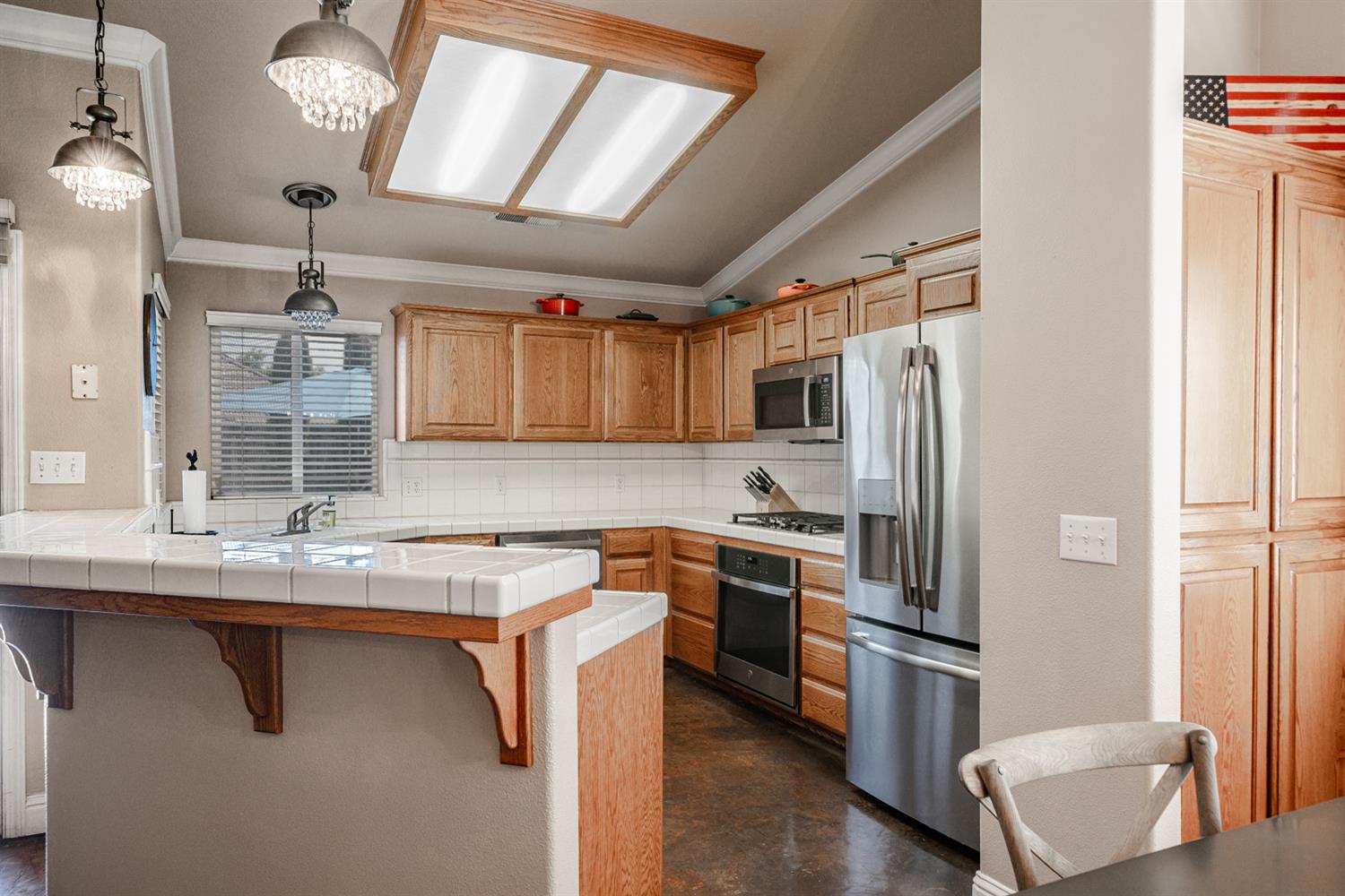 2232 Howard Street Kingsburg, CA 93631 - Photo 14 of 20 a kitchen with refrigerator a sink and chairs