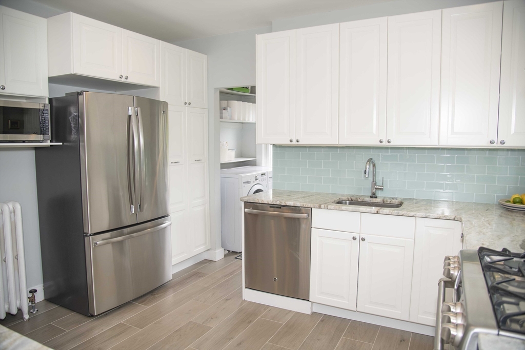 3 Chester Road, Unit 3 Belmont, MA 02478 - Photo 6 of 40 a kitchen with stainless steel appliances granite countertop a refrigerator sink and white cabinets