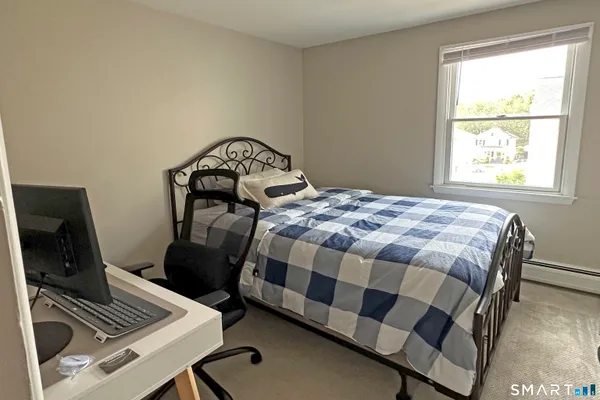 a bedroom with a bed and a window