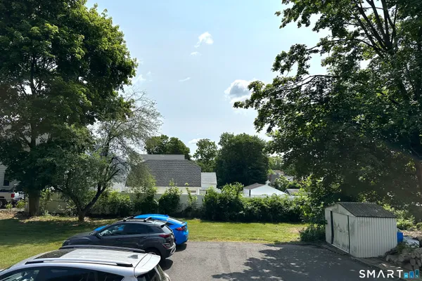 a car parked in front of a house and a yard