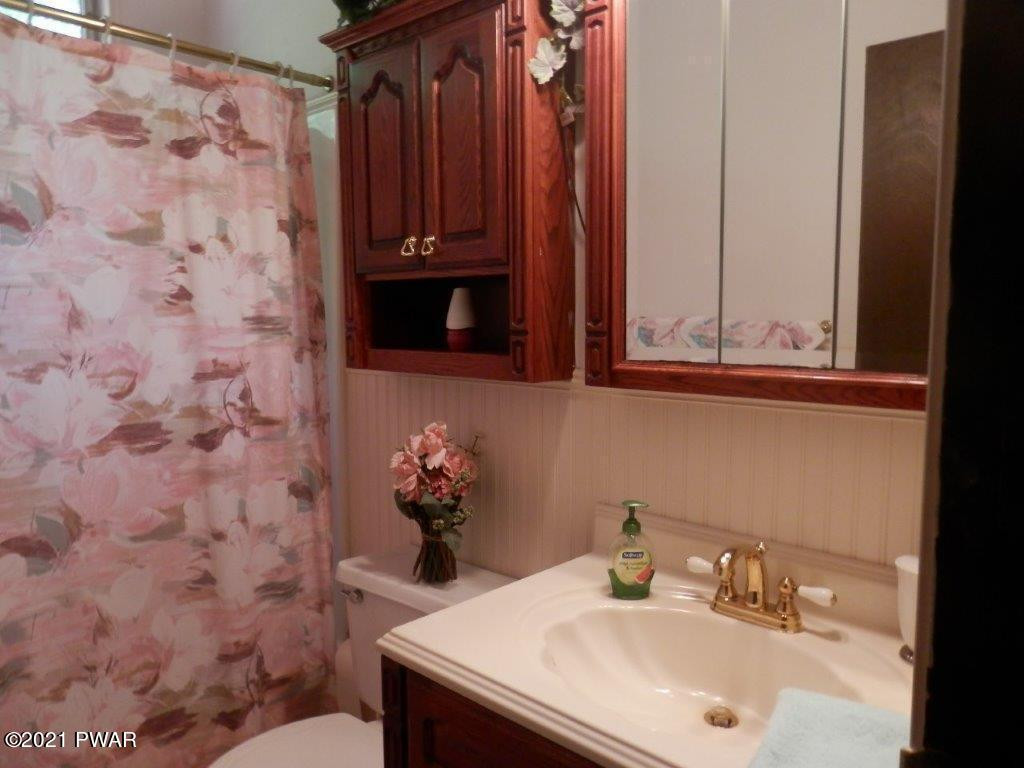 112 Squirrel Road Dingmans Ferry, PA 18328 - Photo 20 of 26 a bathroom with a sink and a mirror
