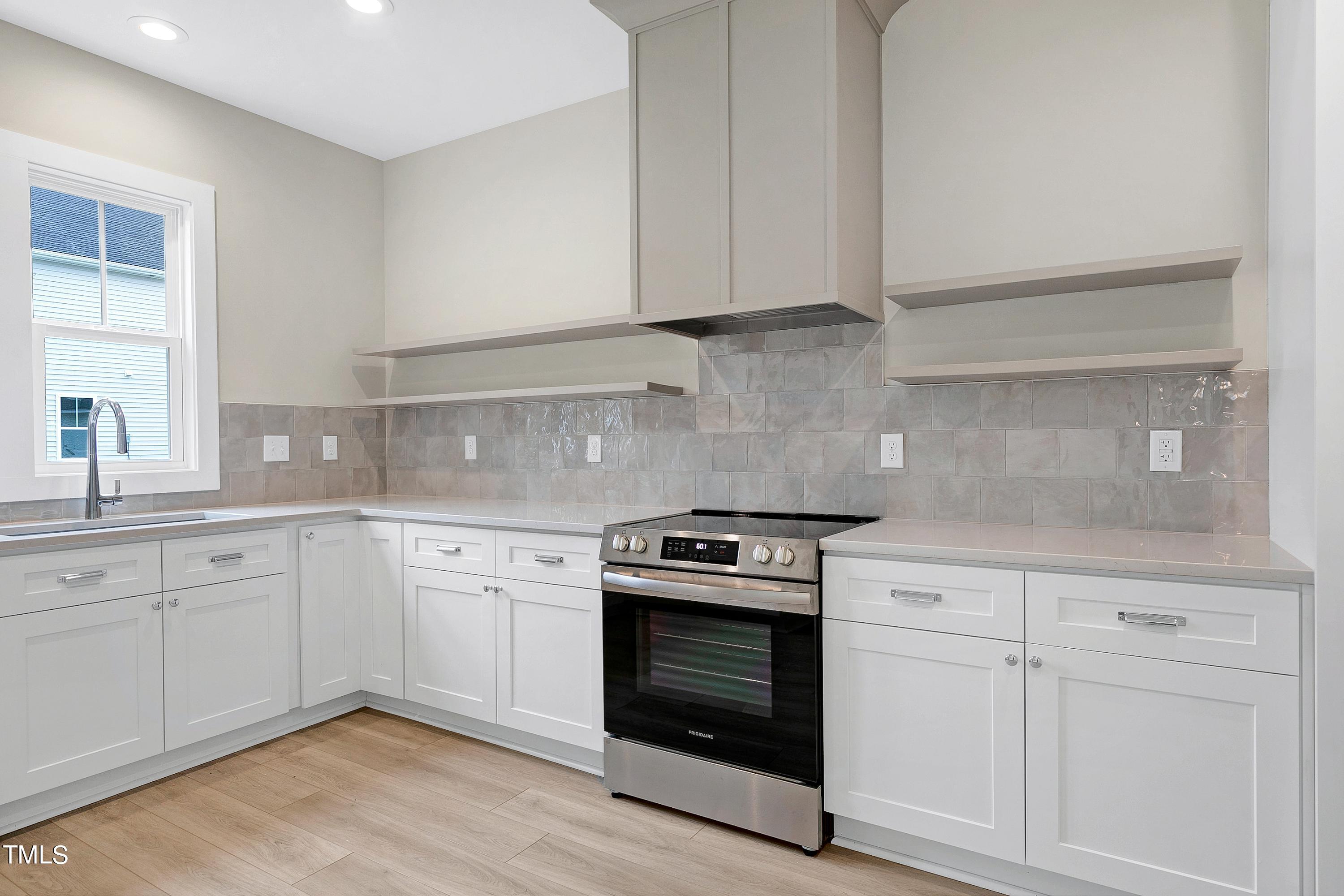 3014 Garner Road Raleigh, NC 27610 - Photo 19 of 39 a kitchen with granite countertop white cabinets and appliances