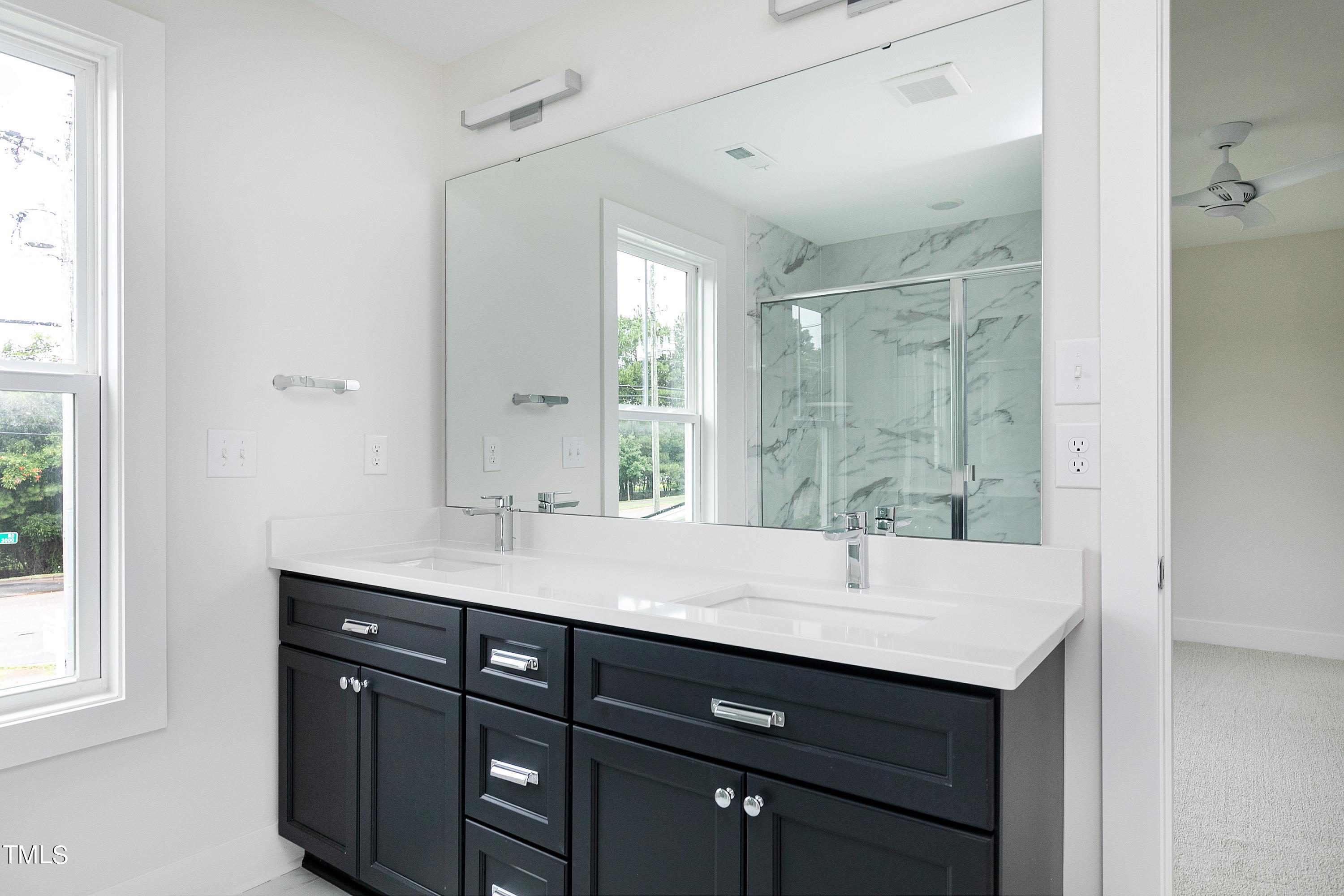 3014 Garner Road Raleigh, NC 27610 - Photo 36 of 39 a bathroom with a sink double vanity and a mirror