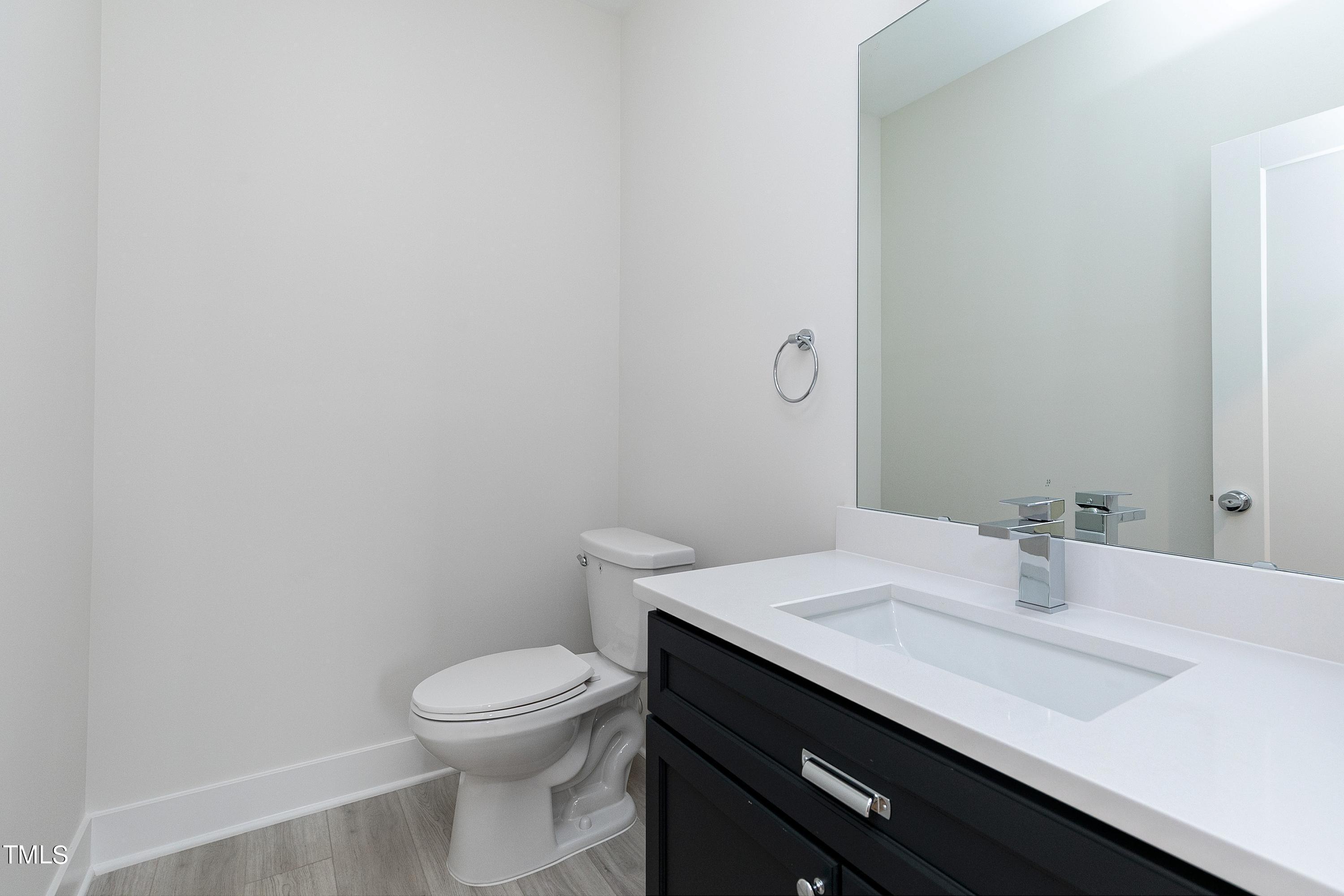 3014 Garner Road Raleigh, NC 27610 - Photo 38 of 39 a bathroom with a sink a toilet and mirror