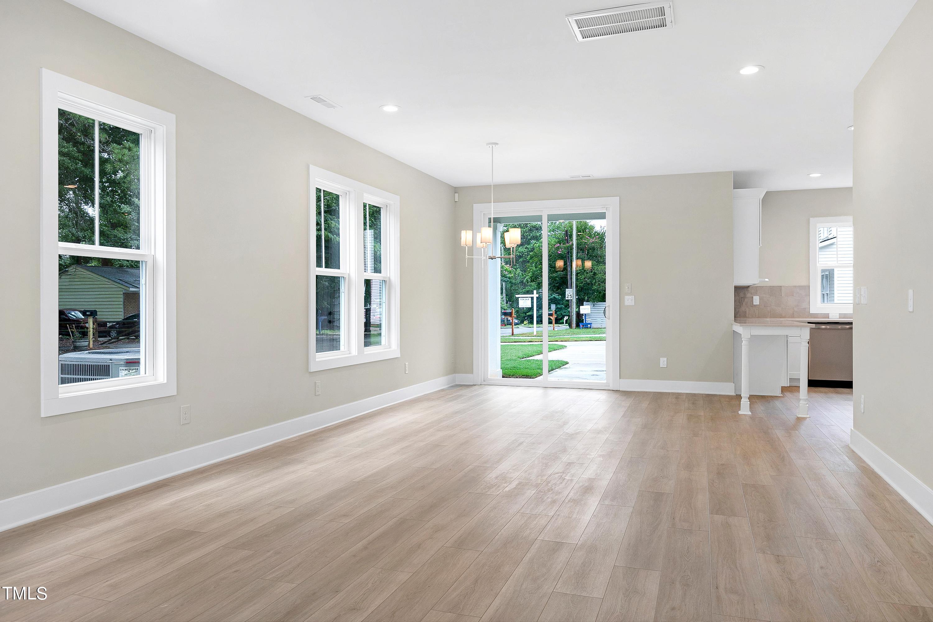 3014 Garner Road Raleigh, NC 27610 - Photo 7 of 39 a view of an empty room with wooden floor and a window