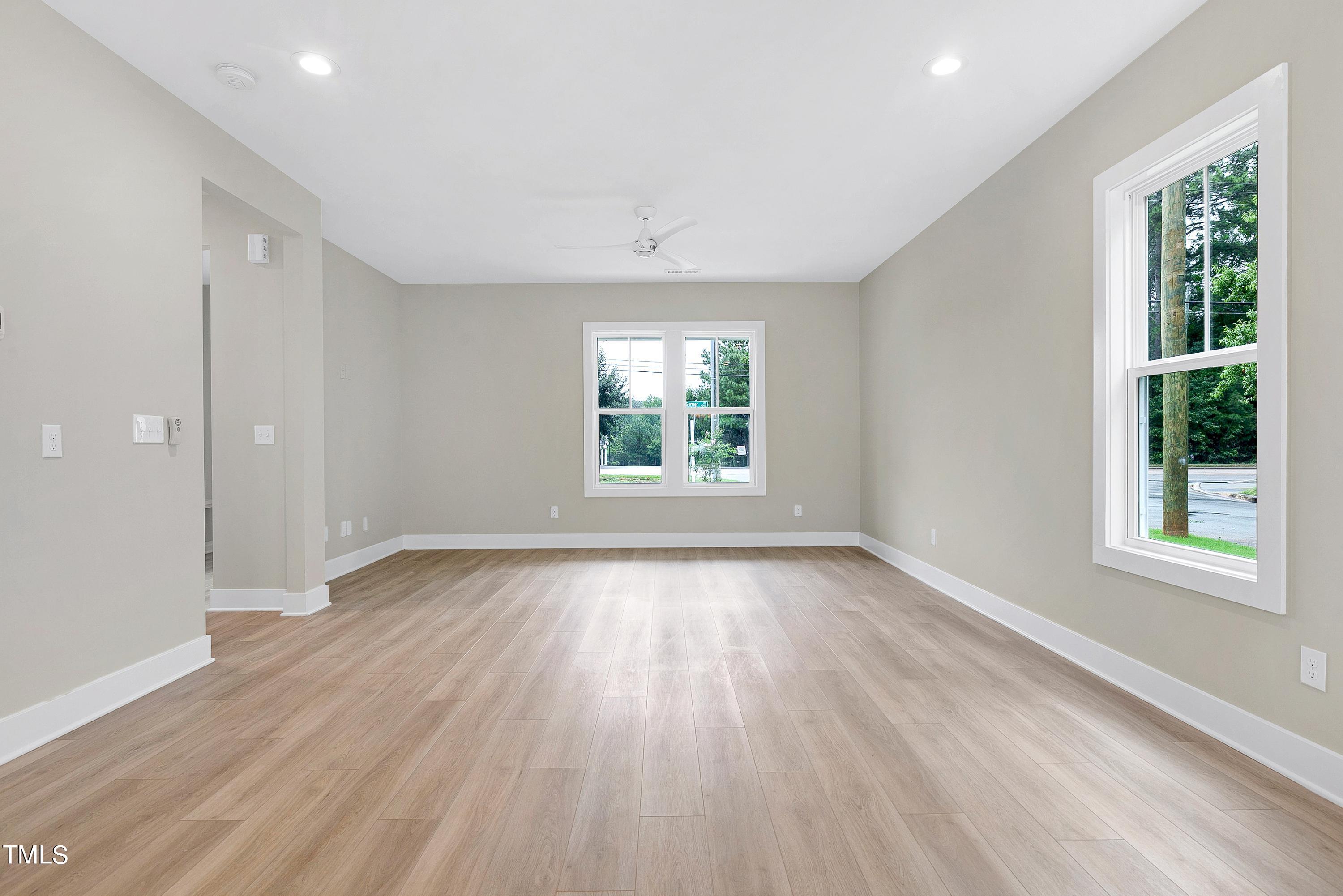 3014 Garner Road Raleigh, NC 27610 - Photo 8 of 39 an empty room with wooden floor and windows