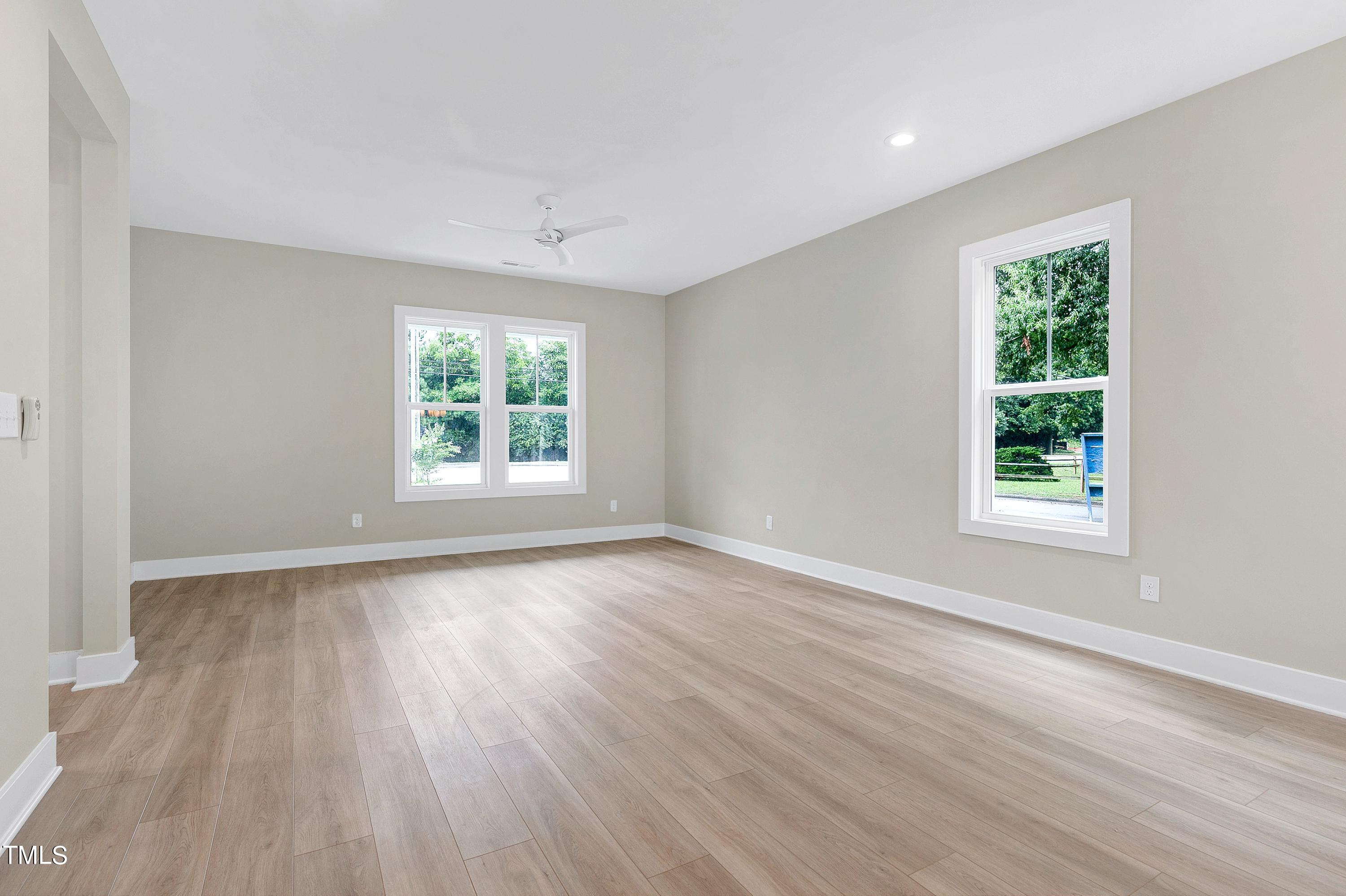 3014 Garner Road Raleigh, NC 27610 - Photo 9 of 39 a view of an empty room with wooden floor and a window