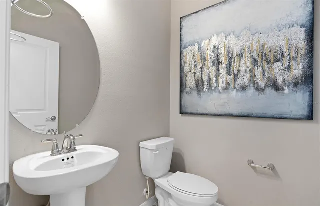 a bedroom with a large bed and wooden floor