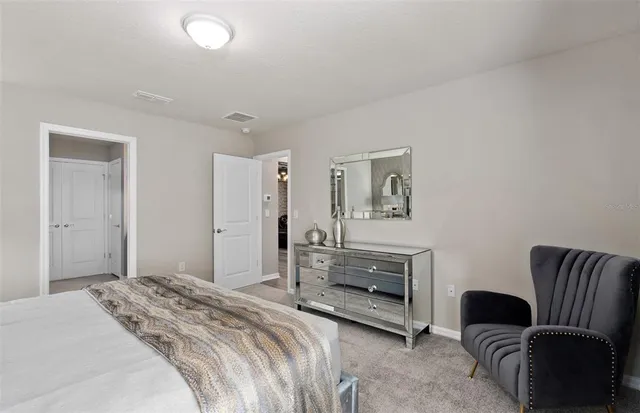 a en suite bathroom with a double vanity sink and a mirror