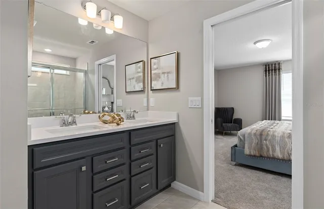 a bathroom with a shower and a glass door