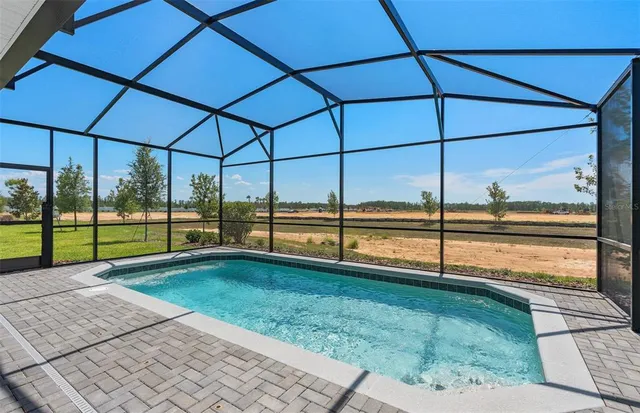a view of an house with backyard porch and furniture