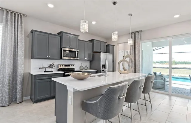 a kitchen with refrigerator and cabinets