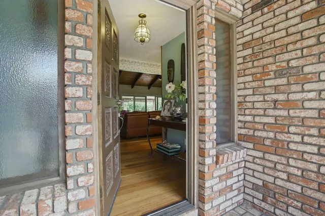 a front view of a house with a garden