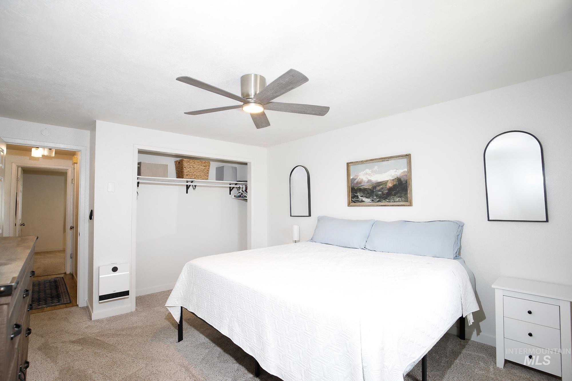 10534 West Fox Ridge Drive Boise, ID 83709 - Photo 9 of 15 Bedroom featuring light colored carpet, a ceiling fan, and a closet
