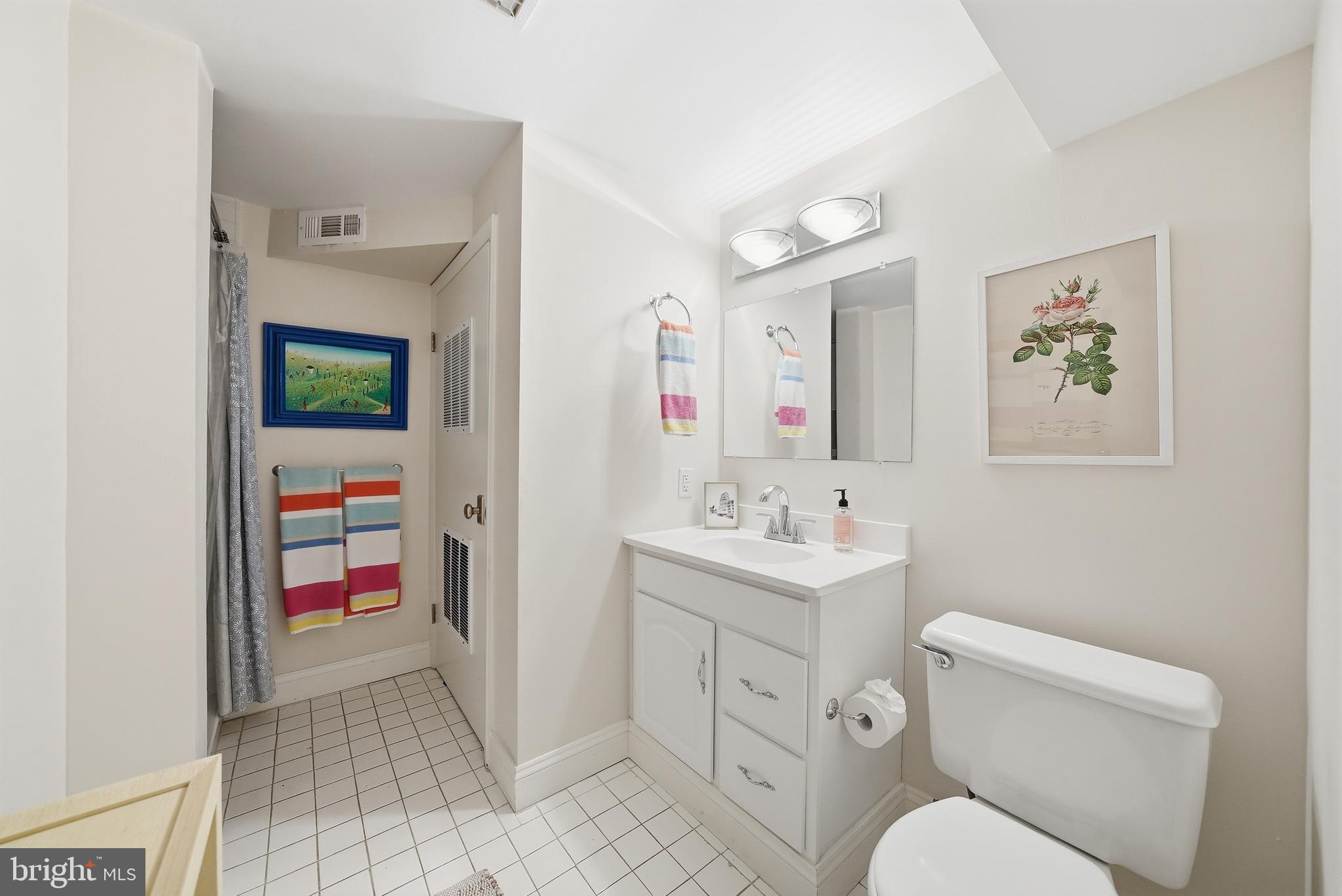 2806 27th Street Northwest Washington, DC 20008 - Photo 27 of 34 a bathroom with a toilet a sink and a mirror