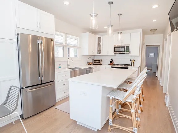 22 North Madison Avenue, Unit 2 La Grange, IL 60525 - Photo 3 of 10 a kitchen with stainless steel appliances a refrigerator sink and microwave