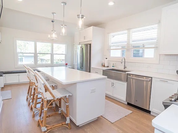 22 North Madison Avenue, Unit 2 La Grange, IL 60525 - Photo 4 of 10 a kitchen with stainless steel appliances granite countertop a stove a sink a refrigerator and white cabinets with wooden floor