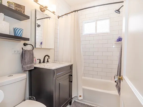 22 North Madison Avenue, Unit 2 La Grange, IL 60525 - Photo 9 of 10 a bathroom with a granite countertop sink a toilet and shower