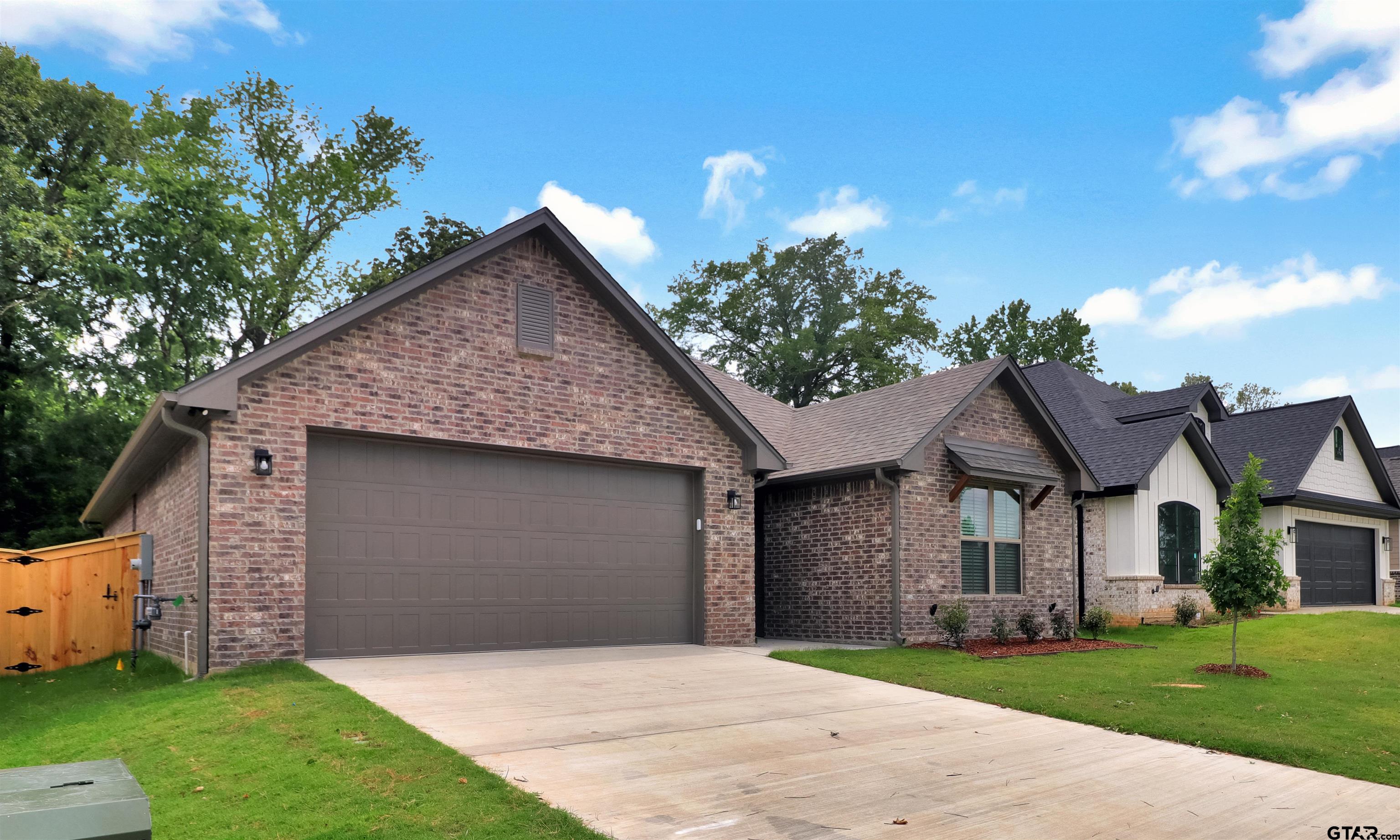 3057 Guinn Farms Road Tyler, TX 75707 - Photo 2 of 32 a front view of a house with a garden and yard