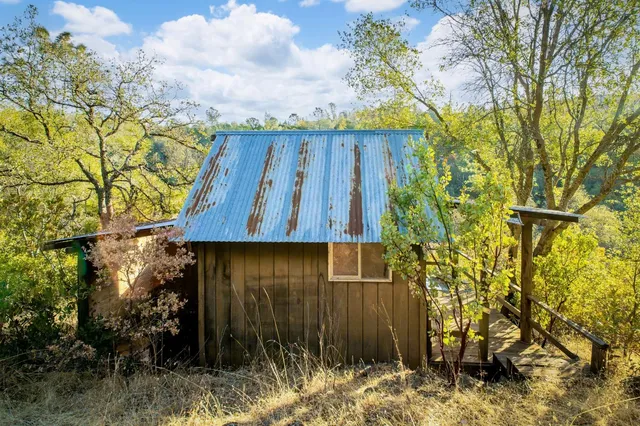 a view of barn house with wooden fence