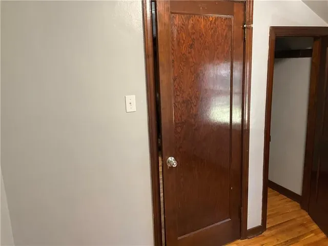 a view of a room with wooden floor and a window