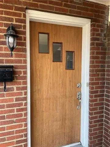 a view of a refrigerator in kitchen and a window