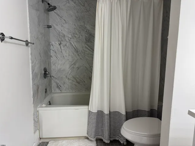 a bathroom with a toilet and a bathtub