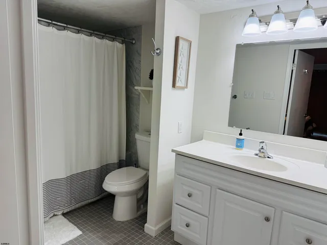 a bathroom with a toilet a sink and a mirror