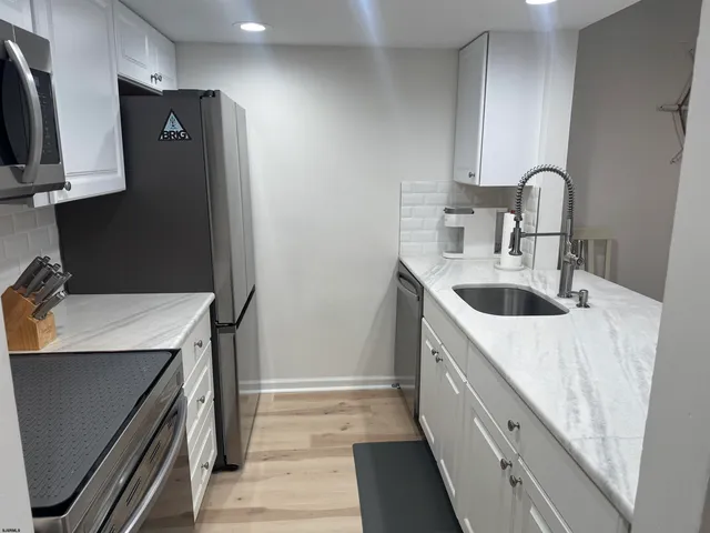 a kitchen with a sink and a refrigerator