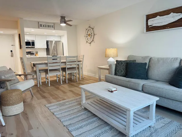 a living room with furniture a rug and white walls
