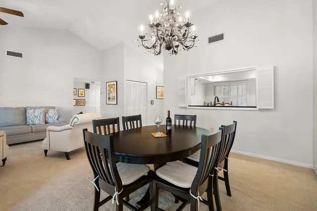a view of a dining room with furniture and chandelier