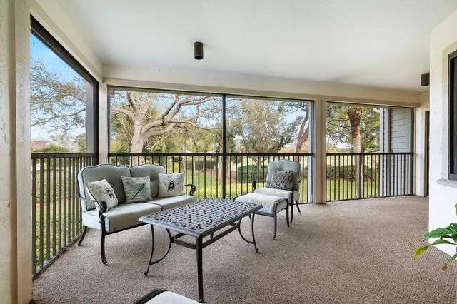 a balcony with furniture and a potted plant