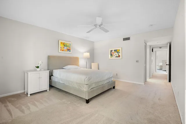 a spacious bedroom with a bed and a chandelier